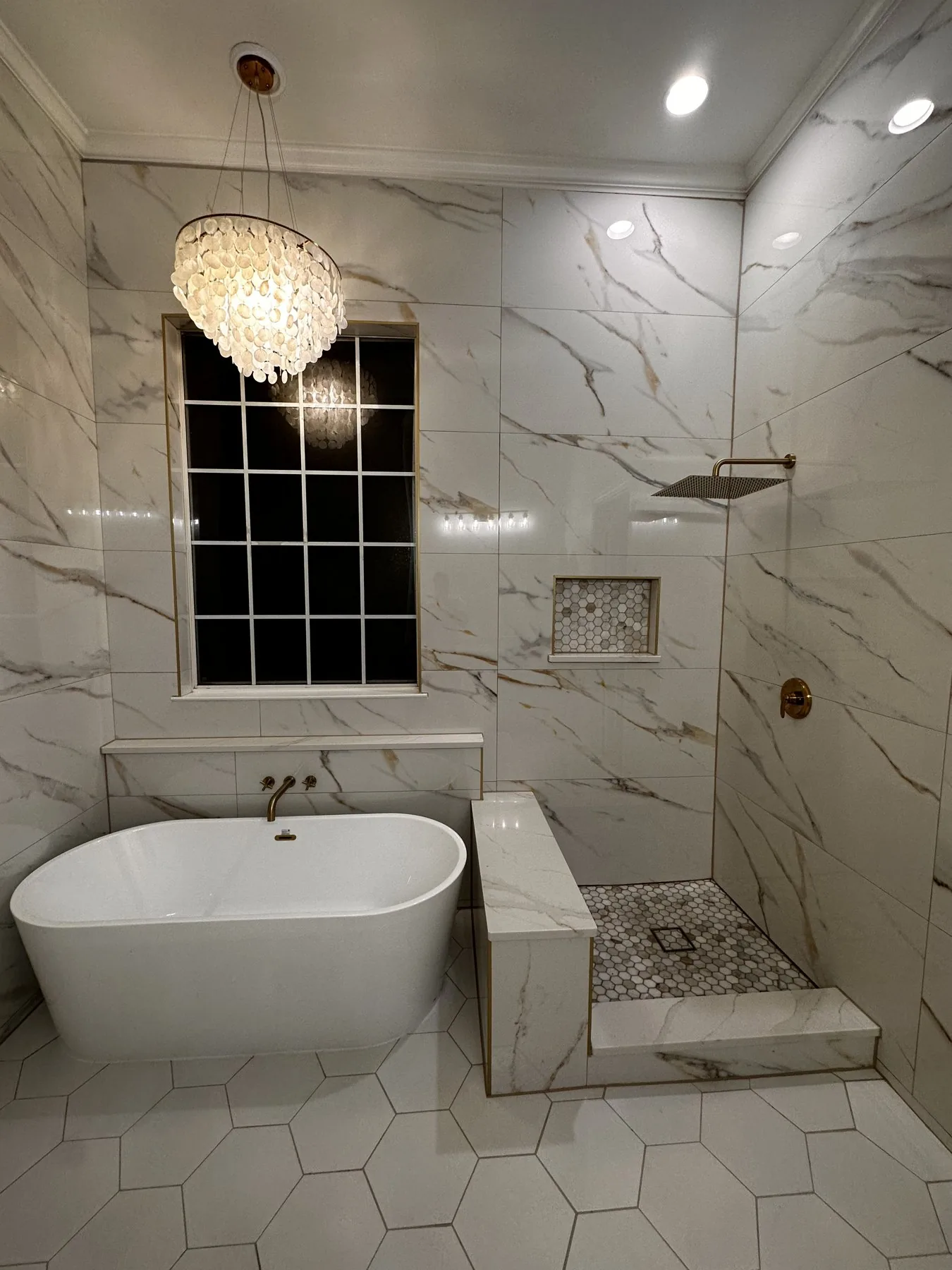 Marble primary bath with freestanding soaking tub, open glass shower, and capiz-shell chandelier — Greenland Hills, Dallas TX