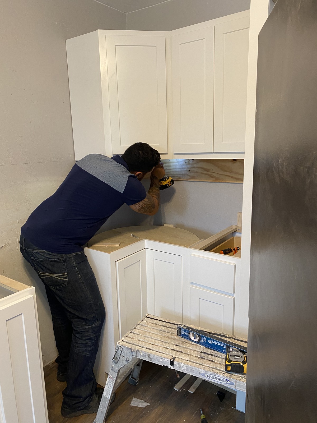 Murillo installing cabinetry on a job site