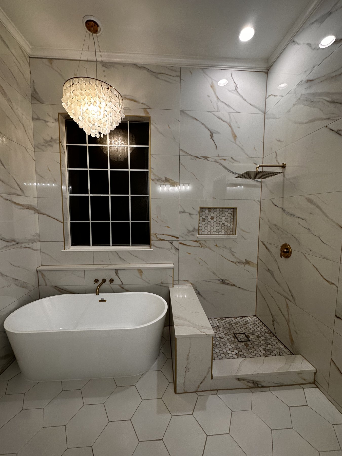 Marble primary bath with freestanding soaking tub, open glass shower, and capiz-shell chandelier — Greenland Hills, Dallas TX